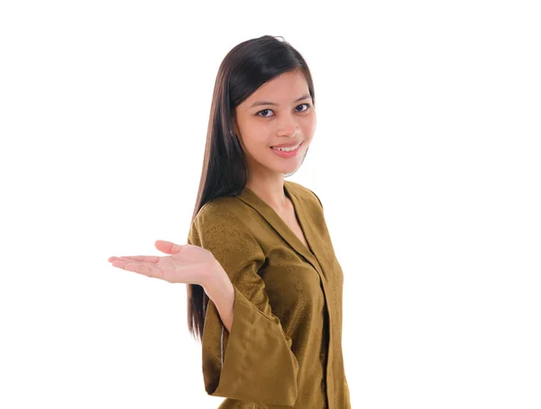 Asian female with batik dress pointing on empty space, over whit — Stock Photo, Image