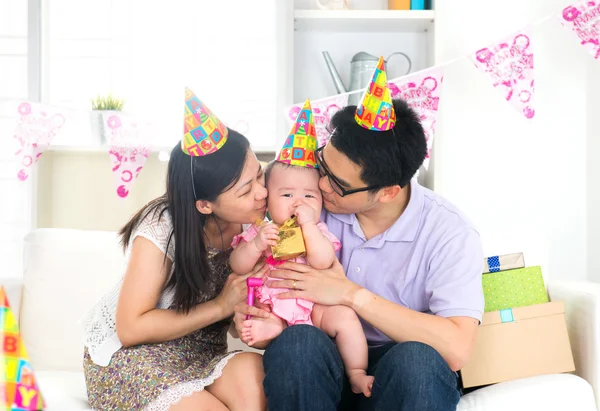 Asian chinese parent kissing baby on birthday party — Stock Photo, Image