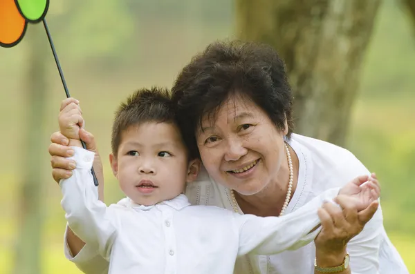 Happy asian grandmother with grandson child playing outdoor — Stock Photo, Image