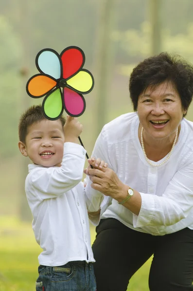 Happy asian grandmother with grandson child playing outdoor — Stock Photo, Image