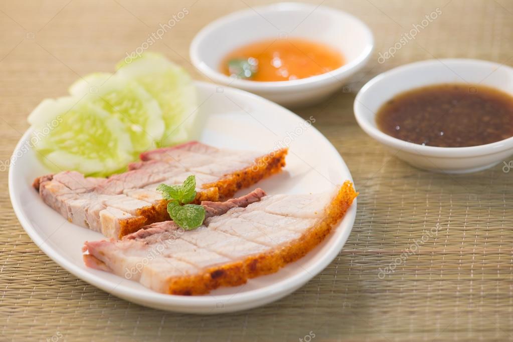 Siu Yuk Chinese roasted pork served with soy and hoisin sauce. Stock