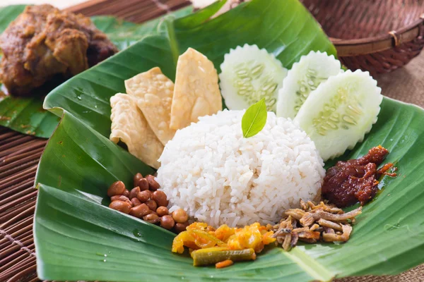 Nasi lemak, a traditional malay curry paste rice dish served on Royalty Free Stock Images