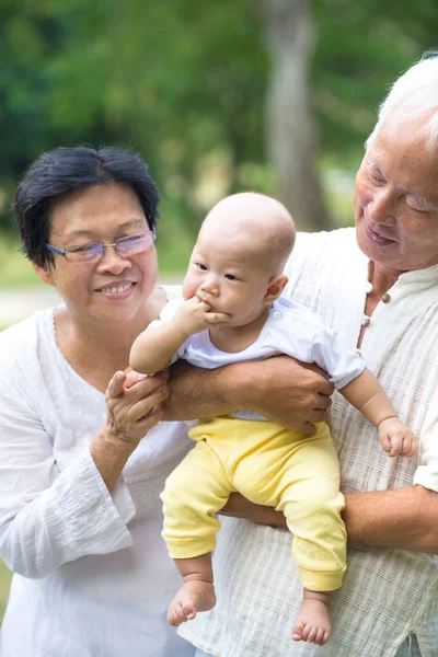 Baby comforted by grandparents — Stock Photo, Image