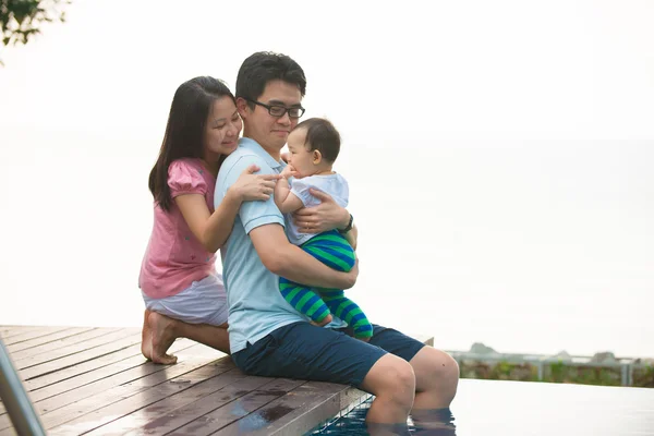 Asian family on a pool — Stock Photo, Image