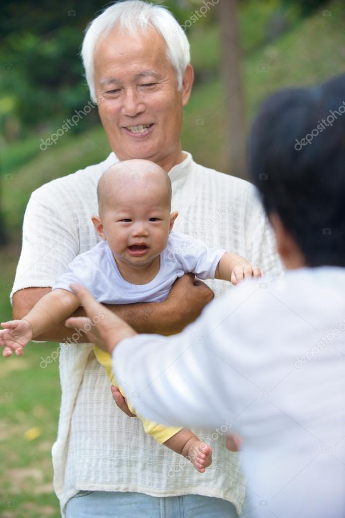 Baby comforted by grandparents