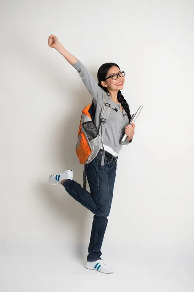 Student jumping in joy with laptop — Stock Photo, Image