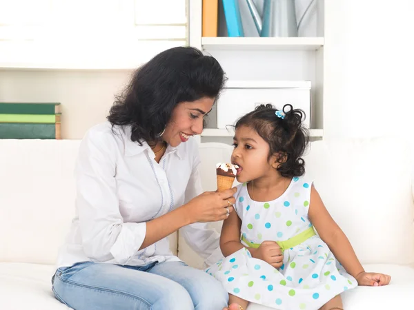 Mother enjoying ice cream with her daughter
