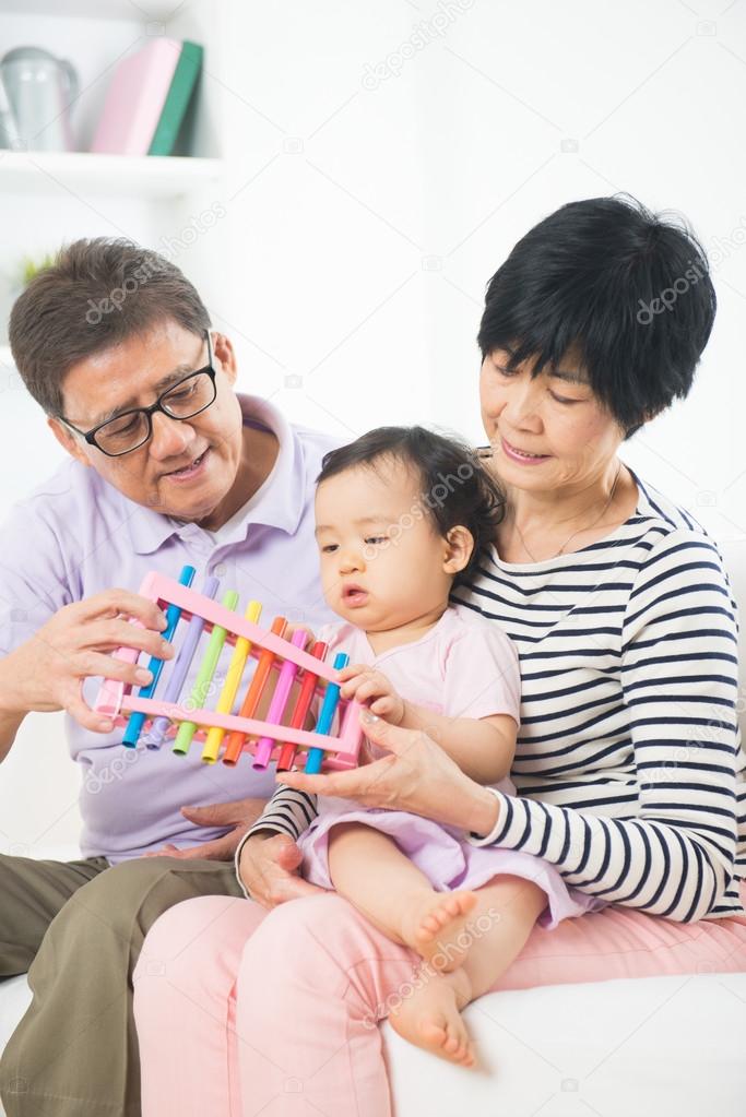 Grand parents teaching granddaughter music