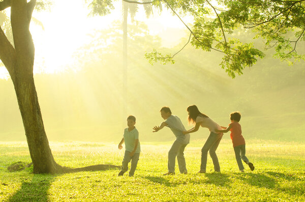 Family playing with joy in park