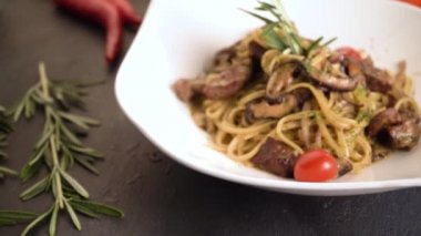close up footage of pasta with meat, tomato sauce and vegetables 
