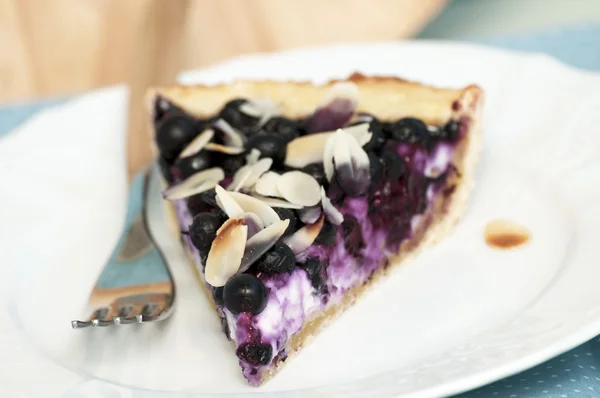 Slice of cheesecake with blueberries and almond — Stock Photo, Image