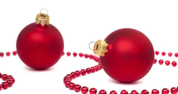 Two red christmas balls isolated on white, focus on right ball — Stock Photo, Image