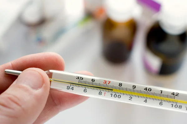 Medicine and thermometer — Stock Photo, Image