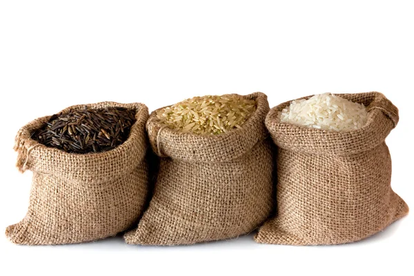 Uncooked rice in small burlap sacks — Stock Photo, Image