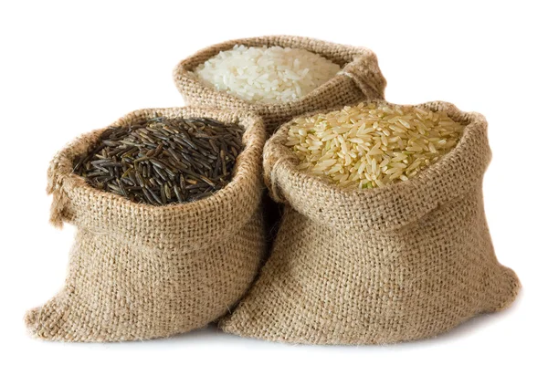 Uncooked rice in small burlap sacks — Stock Photo, Image