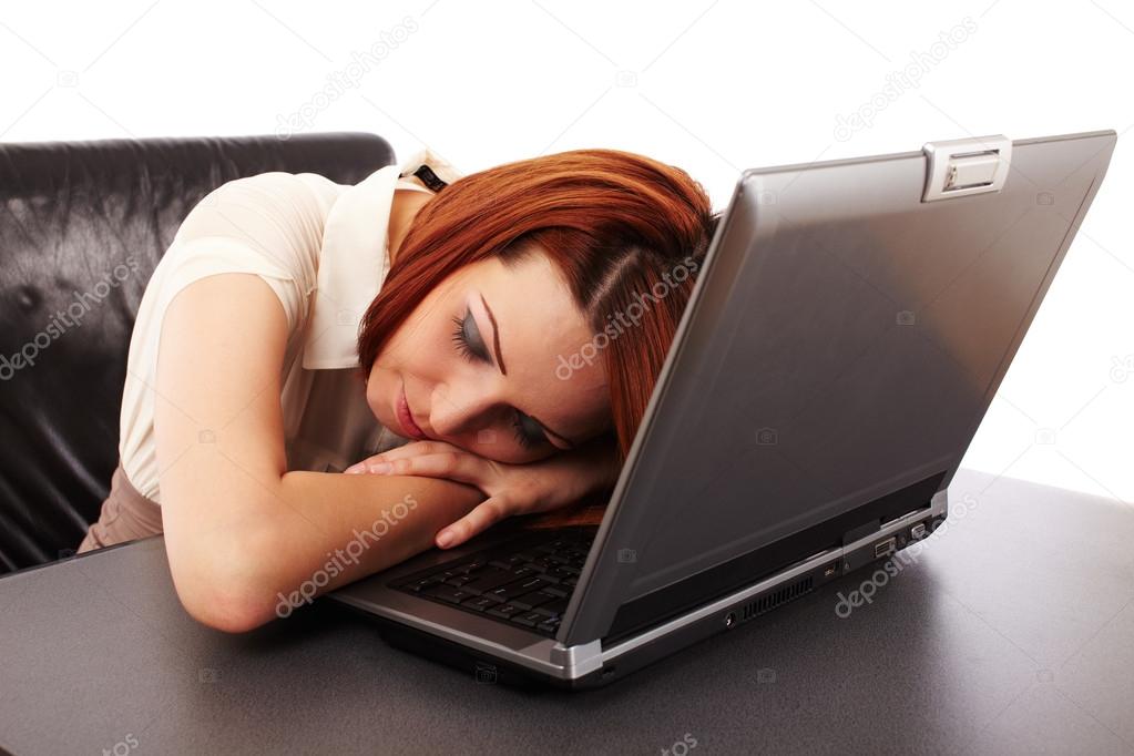 Woman sleeping on her computer