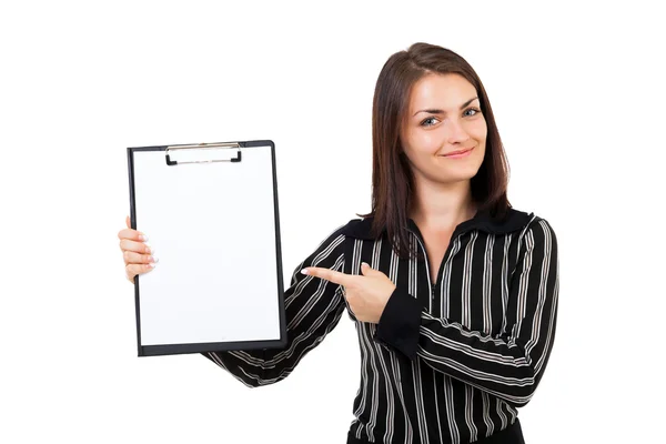 Happy young businesswoman pointing at a clipboard — Stock Photo, Image