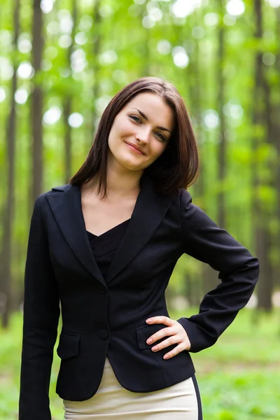 Happy businesswoman with hand on her hip — Stock Photo, Image