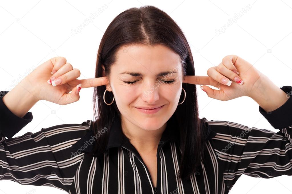 Young businesswoman with fingers in ears
