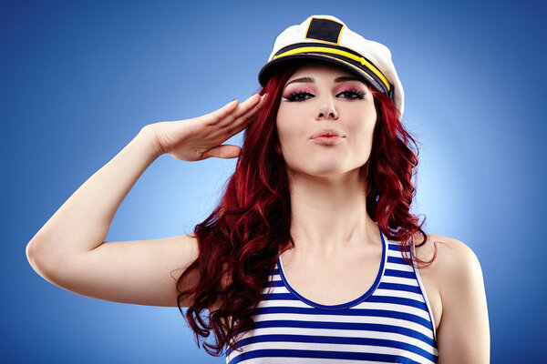 Cute female sailor saluting