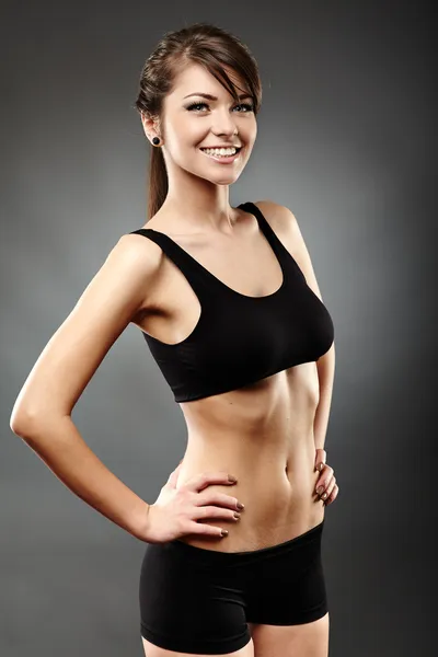 Beautiful sports woman with hand on hips — Stock Photo, Image