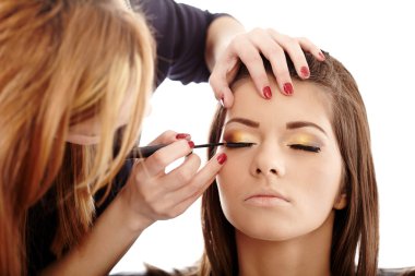 Makeup artist applying makeup clipart