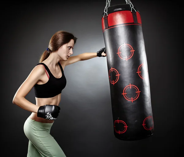 Woman hitting the punching bag — Stock Photo © Xalanx 32087007