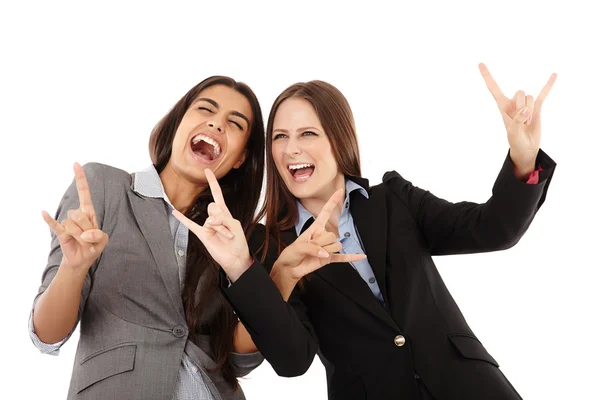 Businesswomen making the rock and roll hand gesture — Stock Photo, Image