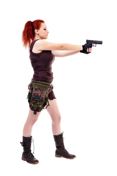 Woman holding a gun and aiming — Stock Photo, Image