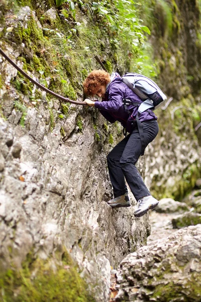 Vrouw klimmen op een berg muur — Stockfoto