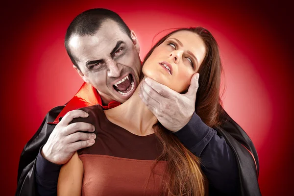 Vampire preparing to bite his victim — Stock Photo, Image