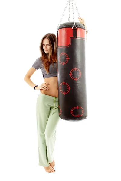 Attractive young woman with punching bag — Stock Photo, Image