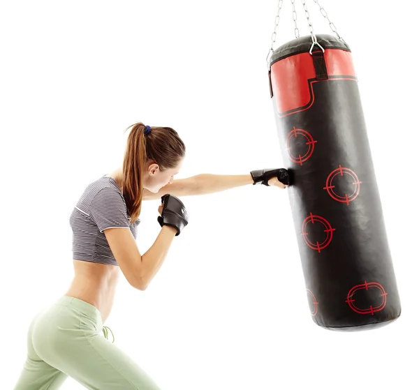 Athletic woman hitting the punching bag — Stock Photo, Image