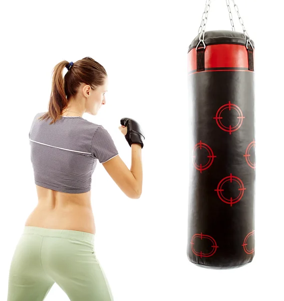 Athletic woman preparing to hit the punching bag — Stock Photo, Image