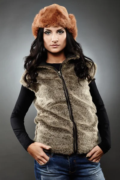 Woman wearing fur vest and cap — Stock Photo, Image