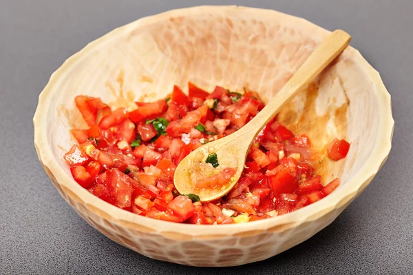 Freshly sliced and diced tomatoes in a wooden bowl — Stock Photo, Image