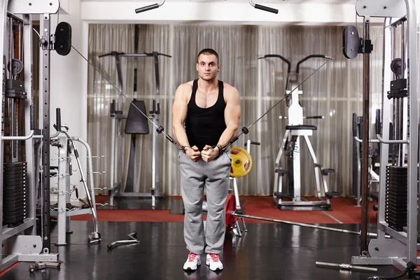 Athletic man pulling heavy weights — Stock Photo, Image