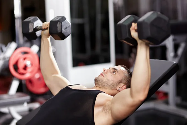 Athletic man working his chest Stock Image