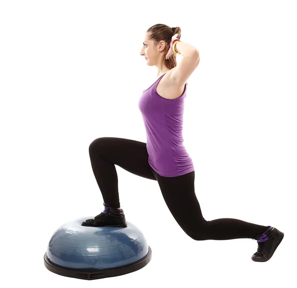 Athletic woman working her legs on a bosu ball — Stock Photo, Image