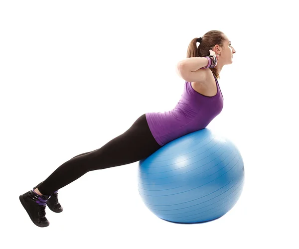 Athletic woman working her back muscles on the ball — Stock Photo, Image