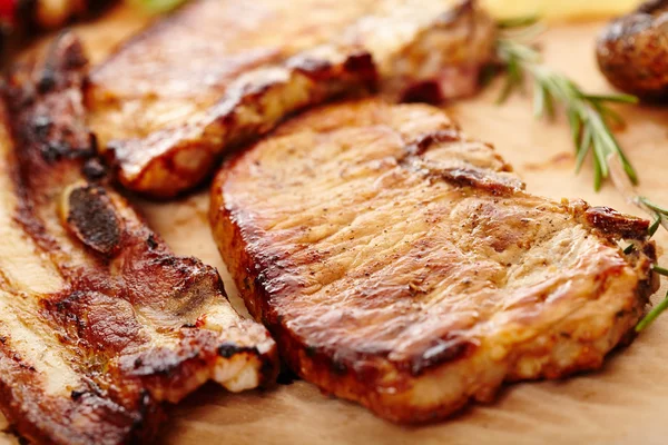 Fried pork meat on a wooden board — Stock Photo, Image