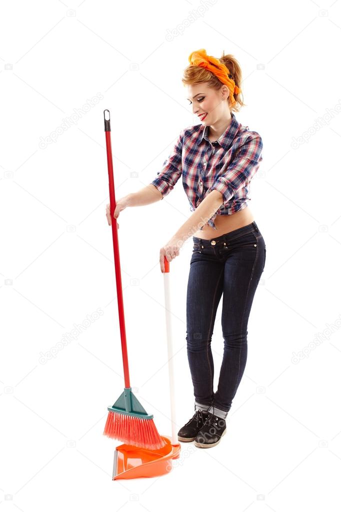 Cheerful housewife sweeping the floor