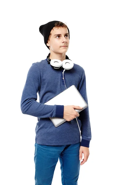 Trendy teenager with headphones holding a tablet — Stock Photo, Image