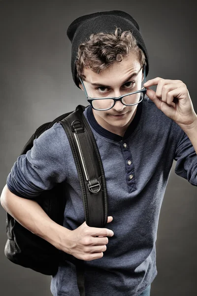 Trendy teenager looking above the glasses — Stock Photo, Image