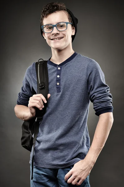Handsome teenager with backpack and wearing glasses — Stock Photo, Image