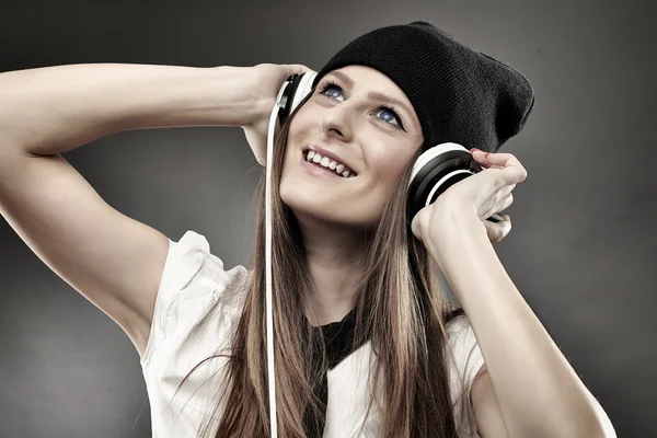 Woman listening to music at headphones — Stock Photo, Image