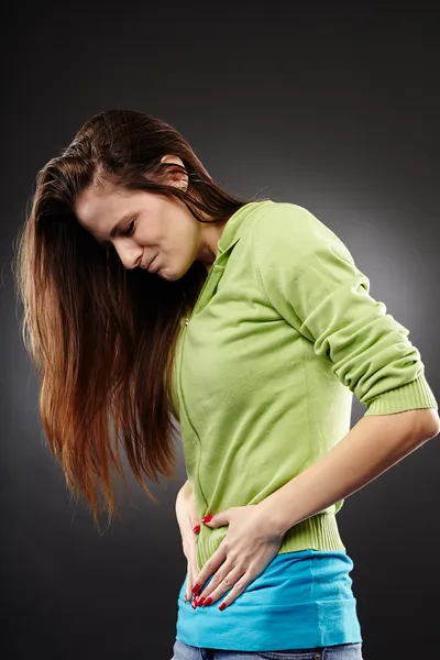 Young woman having a severe abdominal pain — Stock Photo, Image