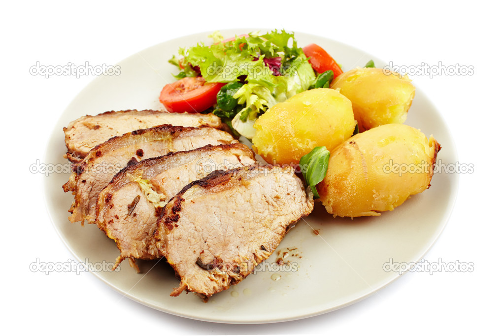 Baked tenderloin garnished with potatoes, lettuce and tomatoes o