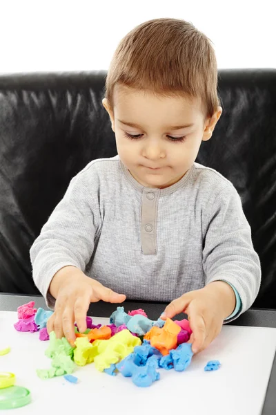 Little boy playing with plasticine — Stock Photo, Image