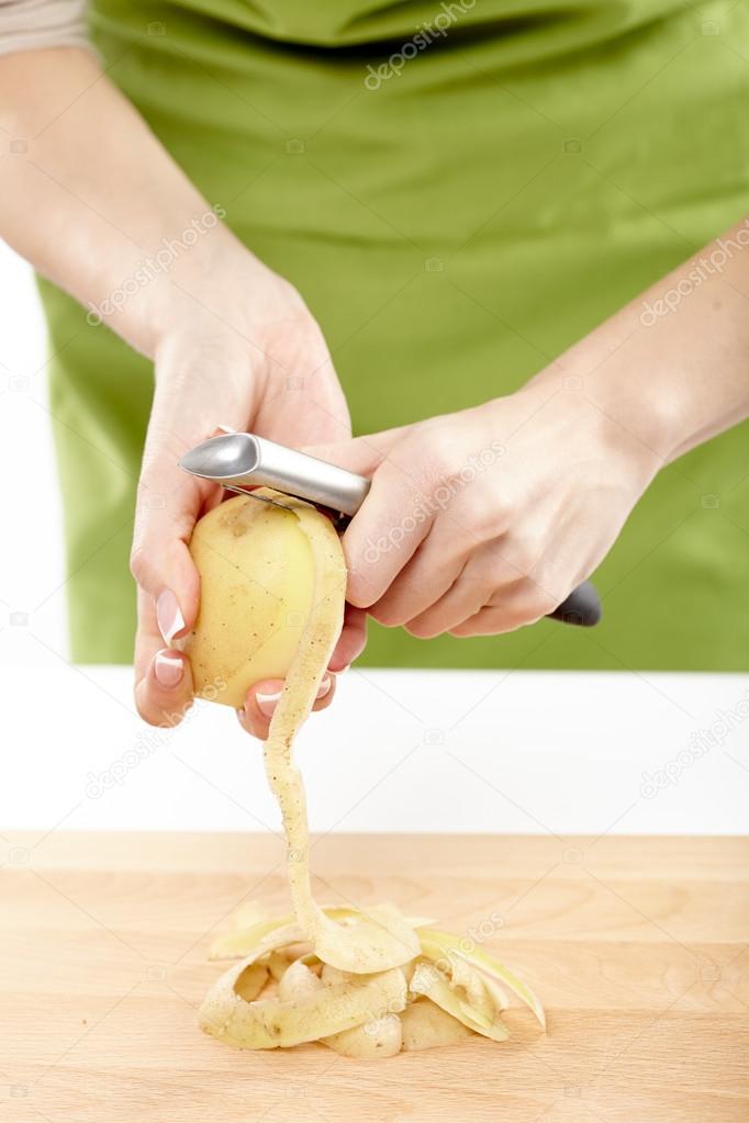 Woman peeling potatoes